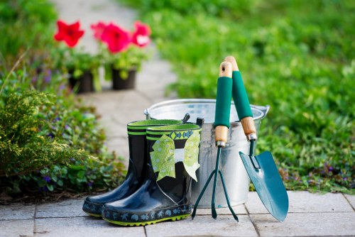 Company van and gardeners preparing tools for a job